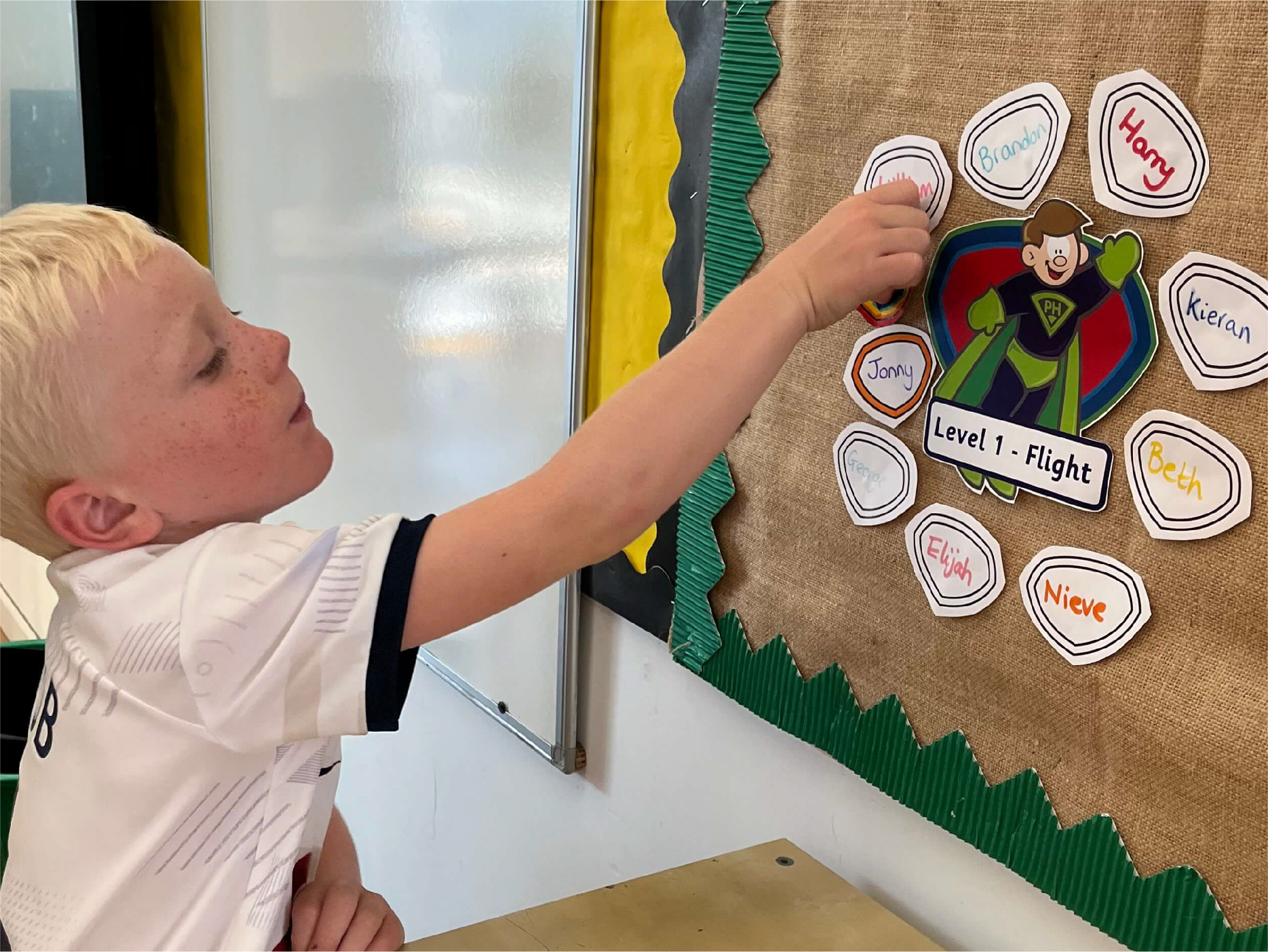 A boy sticking his shield to the wall display