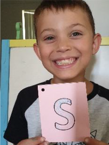 boy holding card with salt letter